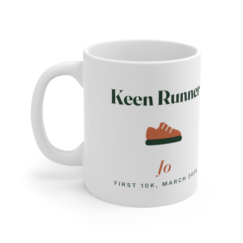 Personalised keen runner mug mock-up, handle on the left, with a terracotta running shoe, 'Jo' and 'First 10K, March 2026'