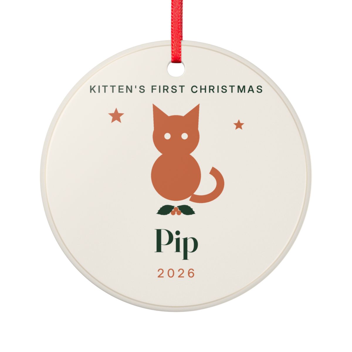 Personalised kitten's first Christmas ornament mock-up, round cream ceramic ornament with an orange cat, holly, 'Pip' and '2026'