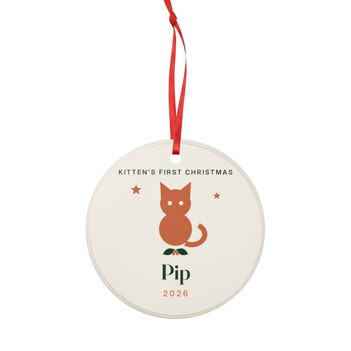 Personalised kitten's first Christmas ornament mock-up hanging from a long red ribbon, whole ornament shown smaller