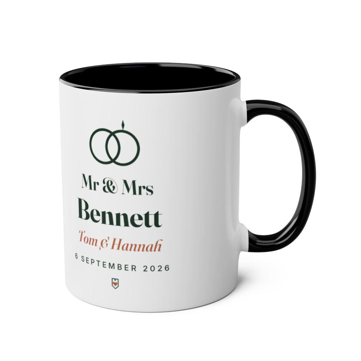 Personalised Mr & Mrs mug mock-up, black two-tone, handle on the right, showing the rings motif and 'Mr & Mrs Bennett'