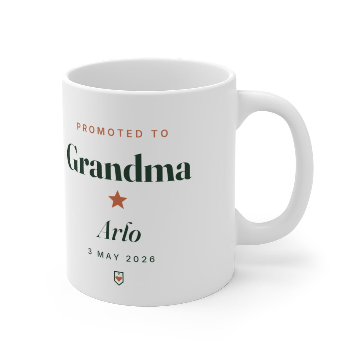 Personalised new Grandma mug mock-up turned with the handle to the right, 'Promoted to Grandma' and a small heart badge