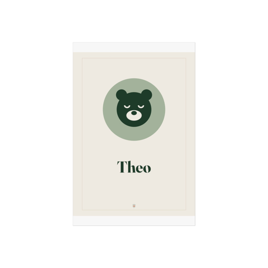 Nursery name print mock-up, unframed, a cream background with a thin border, green bear face and sample name 'Theo'