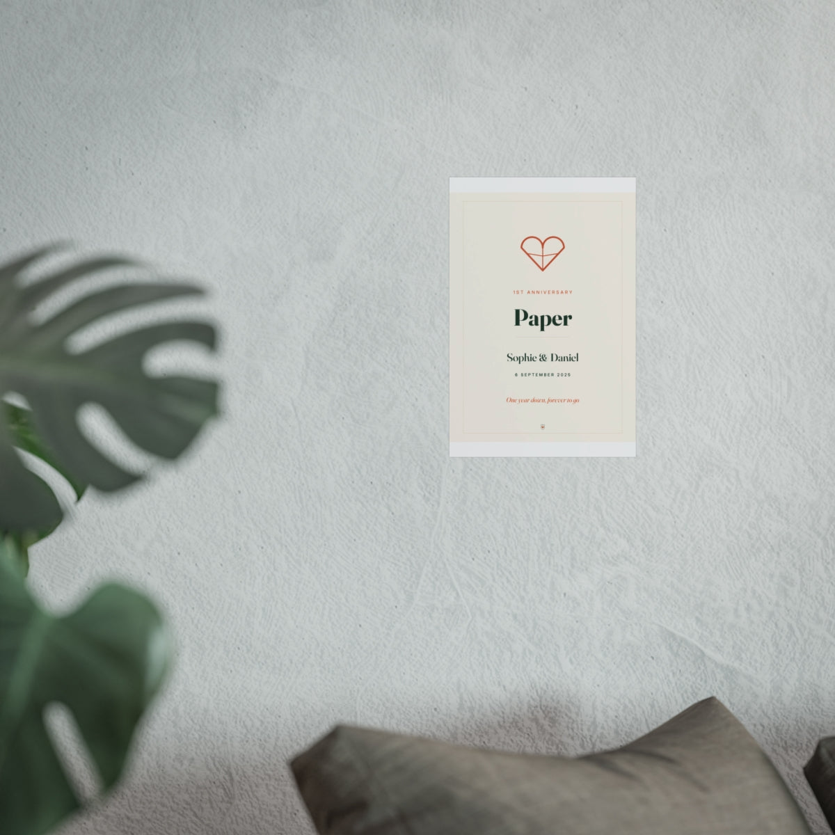 Paper anniversary print mock-up in the smaller size on the grey wall above a sofa cushion, heart and 'Paper' in view