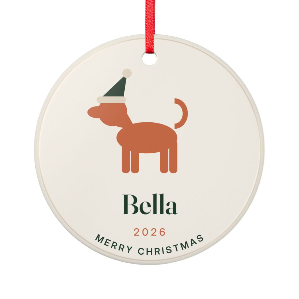 Dog ceramic Christmas ornament mock-up with a red ribbon, a dog in a Santa hat, 'Bella', '2026' and 'Merry Christmas'