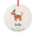 Dog ceramic Christmas ornament mock-up with a red ribbon, a dog in a Santa hat, 'Bella', '2026' and 'Merry Christmas'
