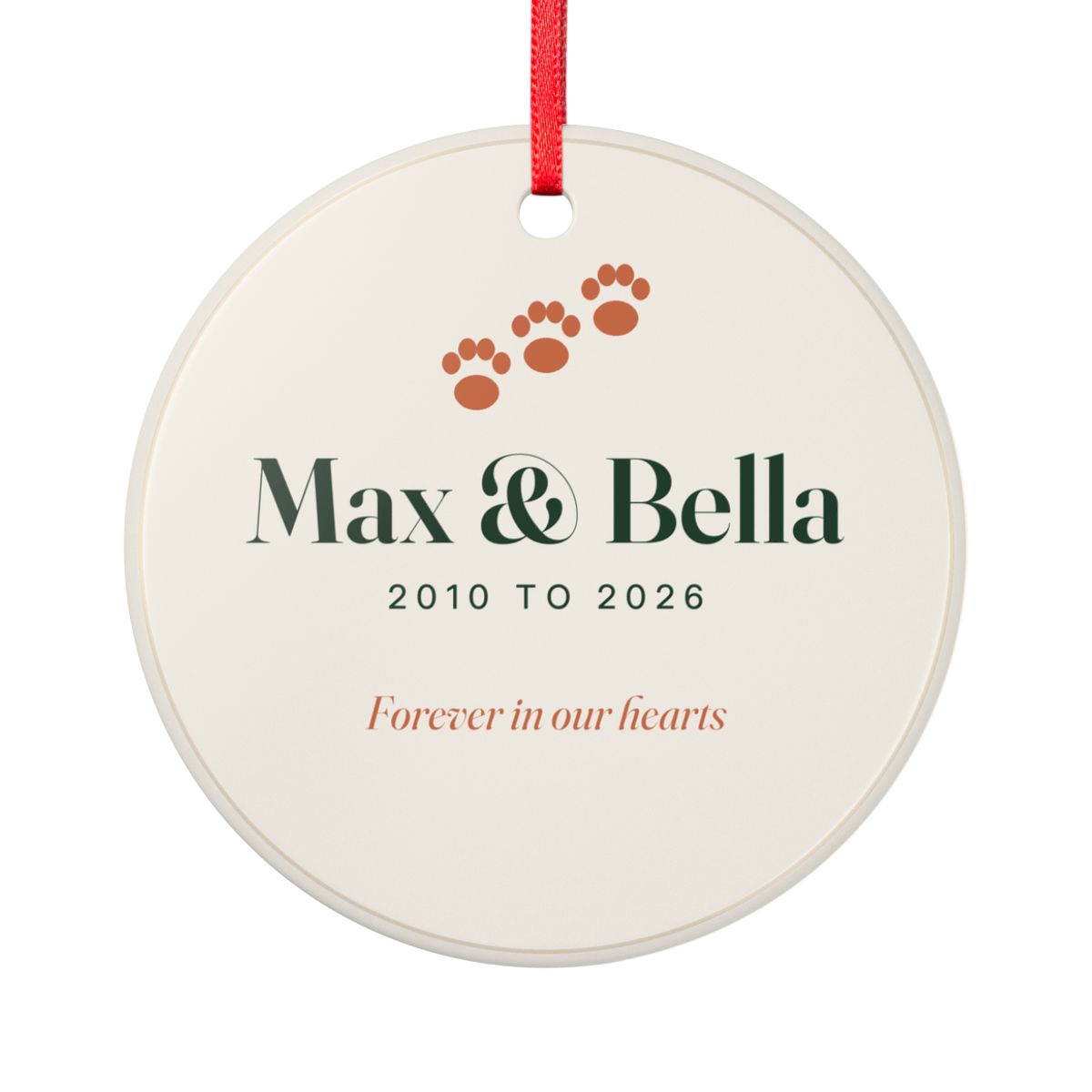 Personalised pet memorial ornament mock-up, round cream ceramic with paw prints, 'Max & Bella' and 'Forever in our hearts'
