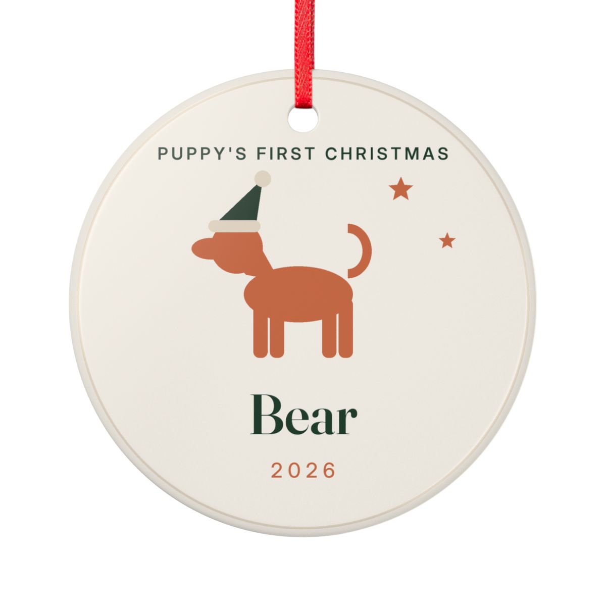 Personalised Puppy's First Christmas ceramic ornament mock-up with a dog in a Santa hat, 'Bear' and '2026', red ribbon