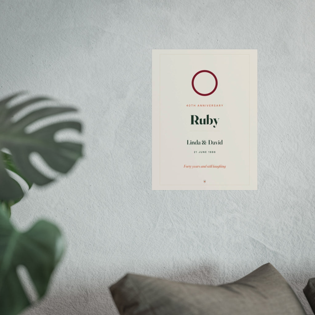 Ruby anniversary print mock-up hung on a pale wall beside a monstera plant and a grey sofa, shown at the larger size