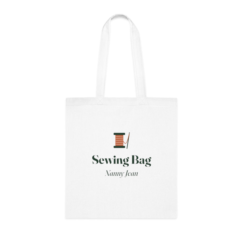Personalised sewing bag tote mock-up, white cotton tote laid flat with a cotton reel, 'Sewing Bag' and 'Nanny Jean'