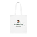 Personalised sewing bag tote mock-up, white cotton tote laid flat with a cotton reel, 'Sewing Bag' and 'Nanny Jean'