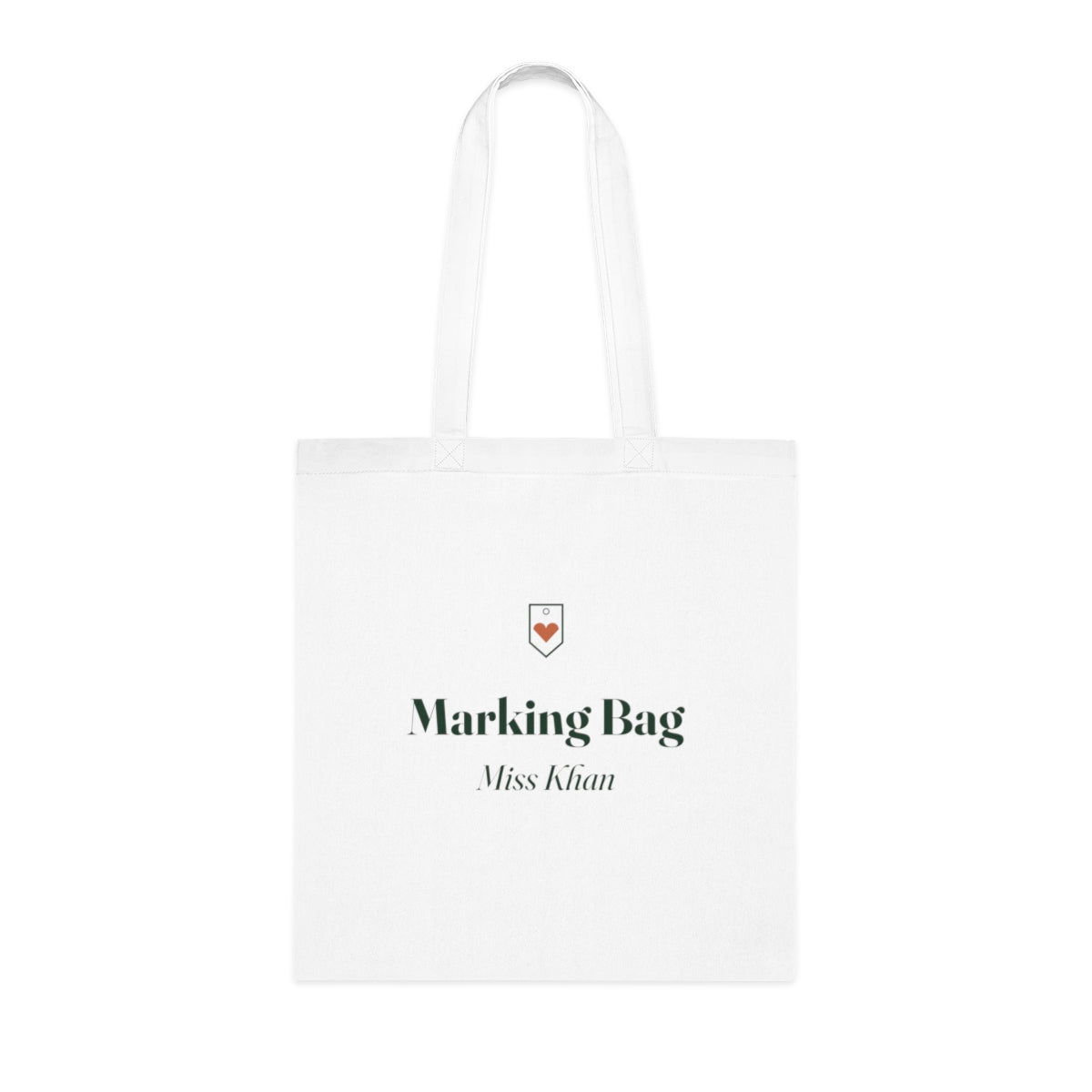 Personalised teacher tote bag mock-up, white cotton tote laid flat with a small heart tag, 'Marking Bag' and 'Miss Khan'