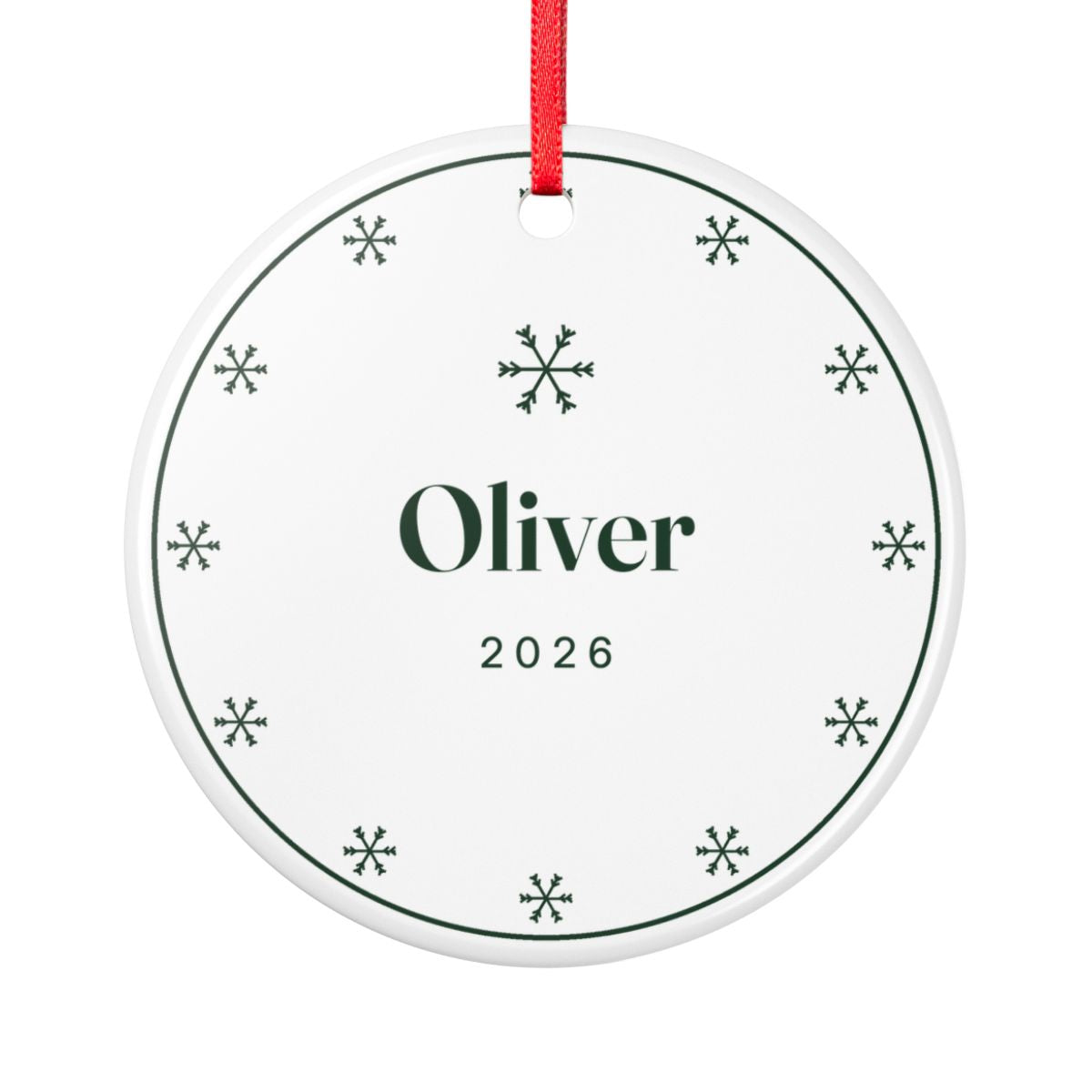 Snowflake ceramic Christmas ornament mock-up, round with a red ribbon, a ring of green snowflakes, 'Oliver' and '2026'
